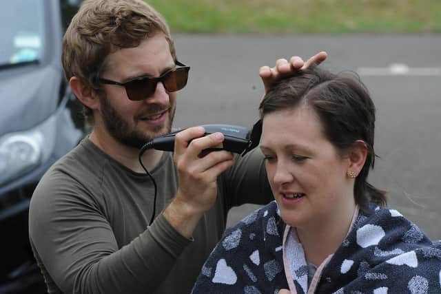 Steve Church cutting the hair with  Jessica Cox