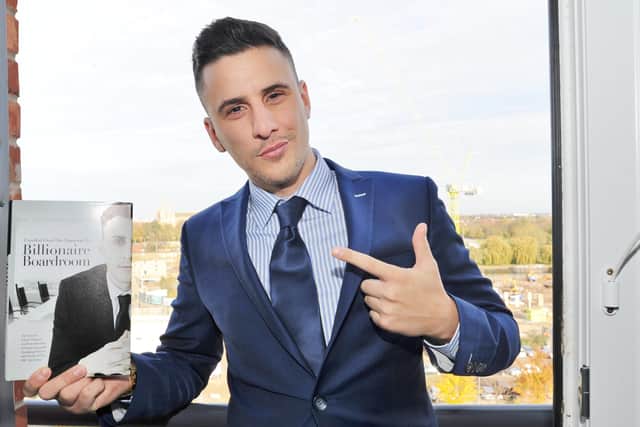 Joseph Valente with his new book at his Peterborough apartment. EMN-171113-153112009