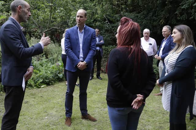 The Duke of Cambridge speaks Steven Pettican, Chief Executive of Light Project Peterborough (left) and people in partnership with the project during a visit to the Garden House part of the Peterborough Light Project. Picture: Kirsty Wigglesworth/PA Wire