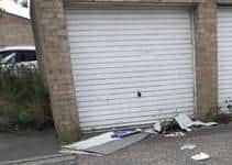 Rubbish left around garages at Branston Rose is branded "a disgrace". EMN-200722-132127001