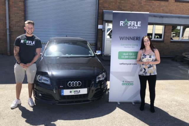 RaffleMyCar's Joey Doyle presents Audi car and 2,000 cash prize to previous raffle winner Carrianne Long from Lincoln