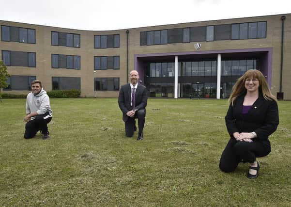 Jack Goodwin, vice chair of Stanground Sports, Kevin Ainslie, Deputy Principal of Stanground Academy and Karina Bonnett, secretary of Stanground Sports, on the new football pitch at the Academy.