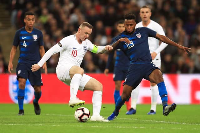 England's Wayne Rooney (left) and USA's Kellyn Acosta battle for the ball during an International friendly at Wembley Stadium, London. Photo: Mike Egerton PA wire.