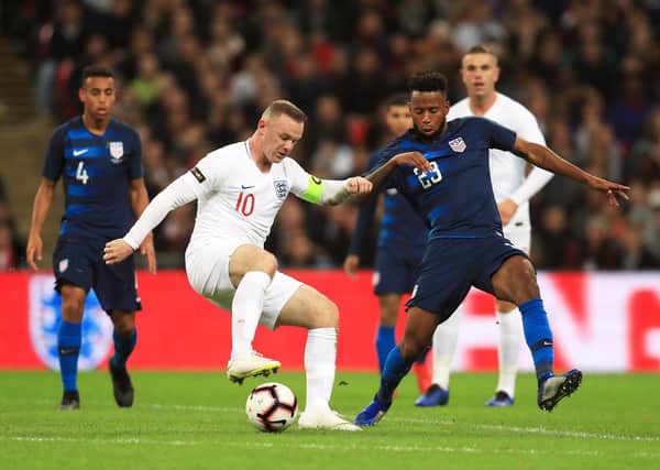 England's Wayne Rooney (left) and USA's Kellyn Acosta battle for the ball during an International friendly at Wembley Stadium, London. Photo: Mike Egerton PA wire.