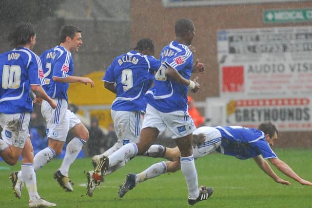 Charlie Lee (diving) celebrates a goal during a 2-0 Posh win over Leicester in 2009.