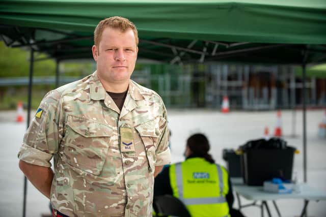 Lance Corporal (LCpl) Kevin Smith, 36 is part of 158 Regiment Royal Logistics Corps (RLC) 160 squadron. Currently working from Harpur Hill, Derbyshire Mobile Testing unit. Working with Civilian contractors handing over the MTU. Cottesmore based soldiers have helped to deliver COVID-19 testing as part of the Government's national testing programme. Soldiers from 7 Regiment RLC based at Kendrew Barracks in Rutland, deployed at the drive-through mobile Coronavirus testing sites across the East Midlands and East Anglia. The Regiment forms part of part of 102 Logistic Brigade and is made up of RLC supply specialists, drivers, chefs as well as REME vehicle mechanics, artificers and clerks. The soldiers had been trained to safely collect swabs at the mobile sites. The mobile facilities can be set up in less than 20 minutes and allow for hundreds of people to be tested each day. Photographer: Cpl Andy Reid / © MoD Crown Copyright 2020 EMN-200730-143517001