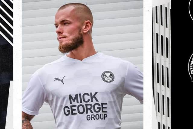 Joe Ward shows off the new Posh third kit for next season.