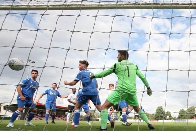 Young Posh player Bradley Rolt's header flies into the net at Stamford AFC. Rolt is almost hidden by the goalkeeper. Photo: Joe Dent/theposh.com.