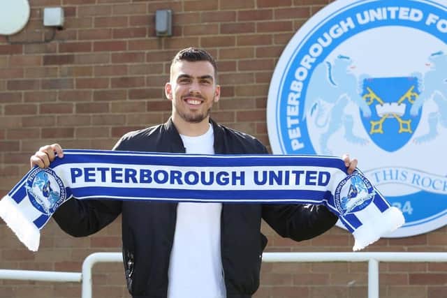 Dan Gyollai poses for the traditional Posh signing picture.