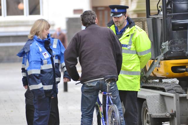 Archive image of a cyclist being challenged in Bridge Street.