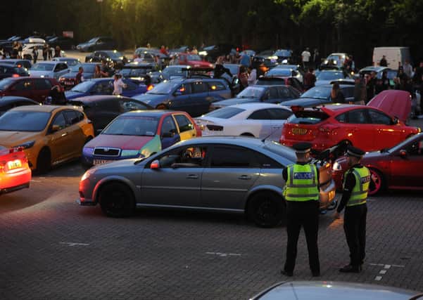 Police at a car meet at Fair Meadow car park in Peterborough last month which sparked a number of complaints from residents about noise.