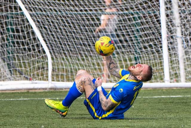 Marcus Maddison in apparent agony while playing for Peterborough Sports against Yaxley. Photo: James Richardson.