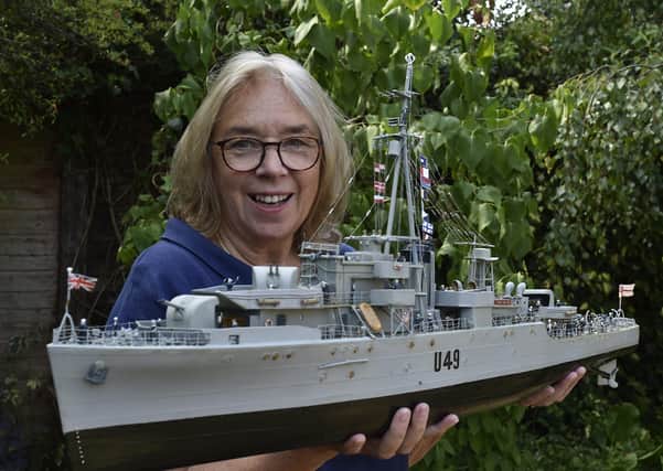 Julie Gibbs with the model of HMS  Pheasant made by her father former Able Seaman Bernard Dowding.