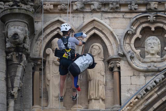 Stonemason Kate Holmes from Architectural & Heritage Scanning Ltd abseils down Peterborough Cathedral to carry out a laser scan on what the team claim is the most digitally recorded historic building in the world, ahead of Westminster Abbey and Notre Dame Cathedral. 
Picture: Joe Giddens/PA Wire