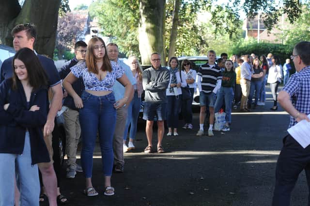 GCSE results day 2020. The King's School students and parents in a queue to get results. EMN-200820-093718009