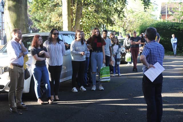 GCSE results day 2020. The King's School students and parents in a queue to get results. EMN-200820-093729009