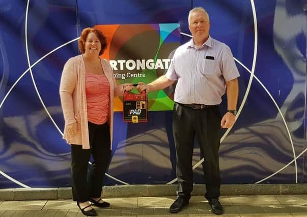 Councillor Kim Aitken and Ortongate Building Manager Colin Donisthorpe at the handing over of the device.