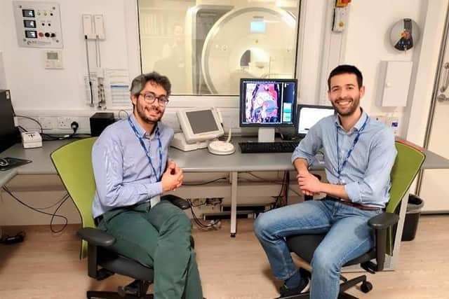 sychiatrist Dr Emanuele Osimo (left) with cardiologist Dr Antonio De Marvao in front of the 3T Magnetic Resonance Imaging (MRI) scanner used for the study in the Robert Steiner MR Unit (Medical Research Council London Institute for Medical Sciences and Imperial College London).