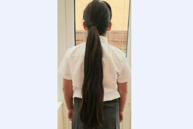 Aimee showing off the length of her ponytail