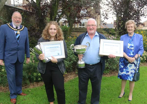 Ellie Nicholls and Phil Knighton receiving their awards from David and Ann Mason