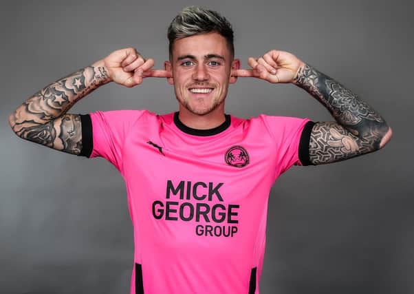 Sammie Szmodics models the new Posh away shirt which is available to buy from 10am on Wednesday. Photo: Joe Dent/theposh.com.