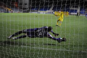 Posh goalkeeper Dan Gyollai saves the penalty from Burton's Ciaran Gillingan to clinch the win for Posh. Photo: David Lowndes.