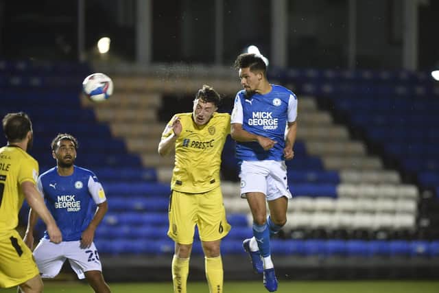 Niall Mason heads the third goal for Posh against Burton. Photo: David Lowndes.