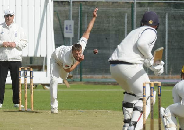 Jamie Smith bowling for Peterborough Town against Rushden.