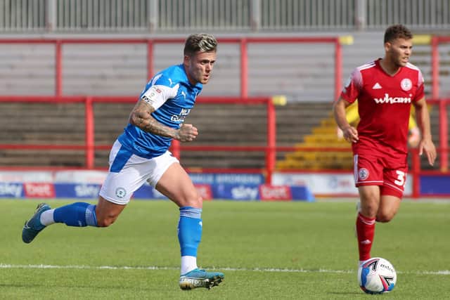 Sammie Szmodics of Posh in action with Dion Charles of Accrington Stanley. Photo: Joe Dent/theposh.com.