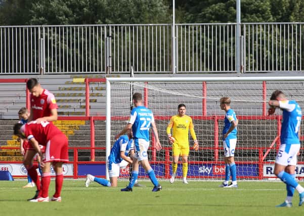 Christy Pym of Peterborough United cuts a dejected figure after Accrington Stanley score the opening goal of the game. Photo: Joe Dent/theposh.com.