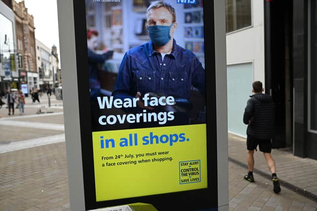Face coverings must be worn in shops (unless people are exempt) (Photo by OLI SCARFF/AFP via Getty Images) SUS-200724-153705001