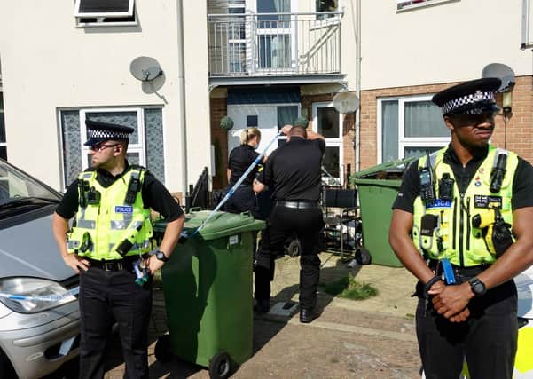 Police standing guard outside the home of Bernadette Walker, 17, at the weekend, whose disappearance is now being treated by police as a "no body" murder. Her parents have appeared in court charged with murder.
