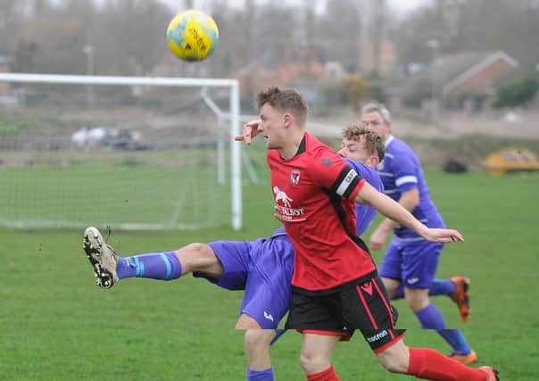 Lewis McManus (red) bagged a hat-trick for Stilton United against Oakham United.
