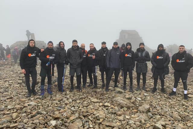 A group of walkers reach the summit in memory of Kasim Ikhlaq