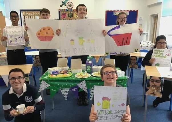 Pupils at Heltwate School show off their banners for the virtual coffee morning