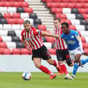 Siriki Dembele of Peterborough United takes on the Sunderland defence . Photo; Joe Dent/theposh.com.