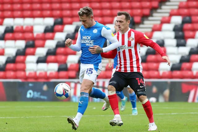 Sammie Szmodics of Peterborough United in action with Josh Scowen of Sunderland. Photo: Joe Dent/theposh.com.