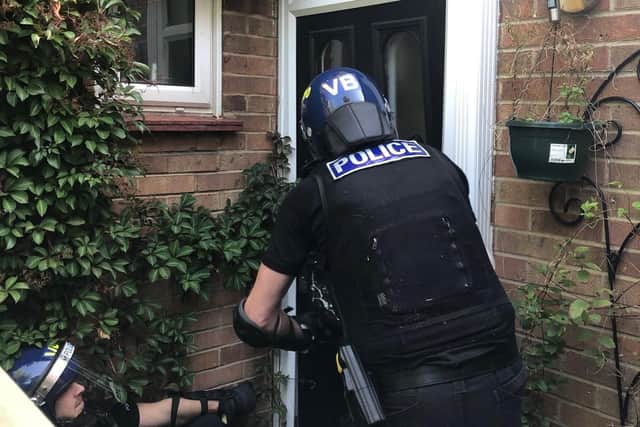 Police taking part in the raid in Cambridge. Pic: Cambs Police