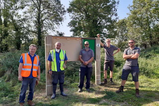 Members of the Nene Park Trust Park Management Team and Antomic Woodworking in Leicester installing the signs