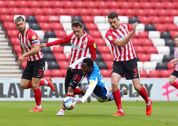 Siriki Dembele of Peterborough United is brought down by the Sunderland defence. Photo: Joe Dent/theposh.com.