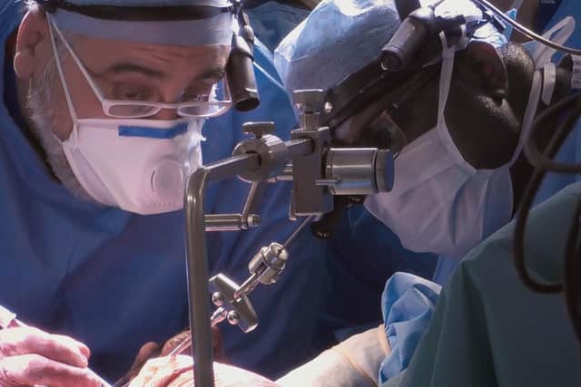 Aman Coonar and Professor Charles Malata operating on Kevin. Photo credit: BBC/Dragonfly
