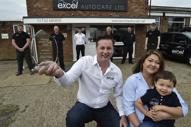 Peterborough Telegraph Garage of the Year winner Excel Auto Care at Yaxley.  Proprietor Nick Heyes with partner Francine-Nguyen-Van-Tam and son Ethan Heyes (2) and staff at the garage. EMN-200110-164252009