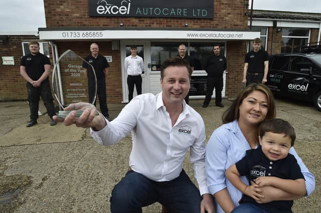 Peterborough Telegraph Garage of the Year winner Excel Auto Care at Yaxley.  Proprietor Nick Heyes with partner Francine-Nguyen-Van-Tam and son Ethan Heyes (2) and staff at the garage. EMN-200110-164252009