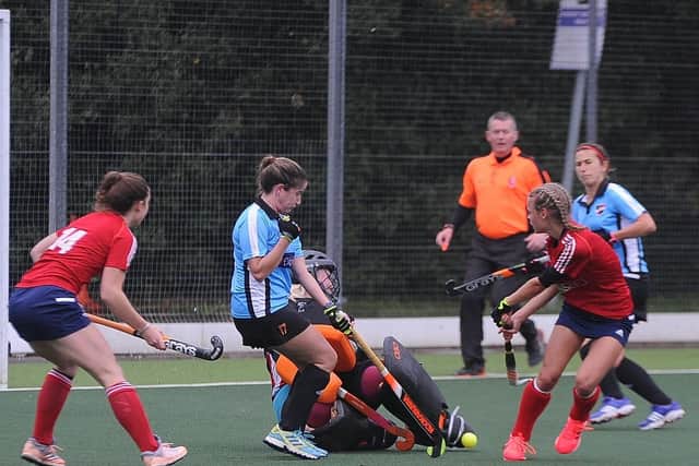 Action from City of Peterborough Ladies (red) 6, Ipswich & East Suffolk 0. Photo: David Lowndes.