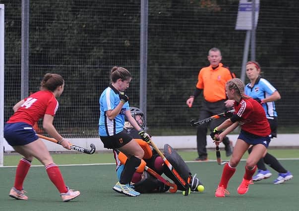 Action from City of Peterborough Ladies (red) 6, Ipswich & East Suffolk 0. Photo: David Lowndes.