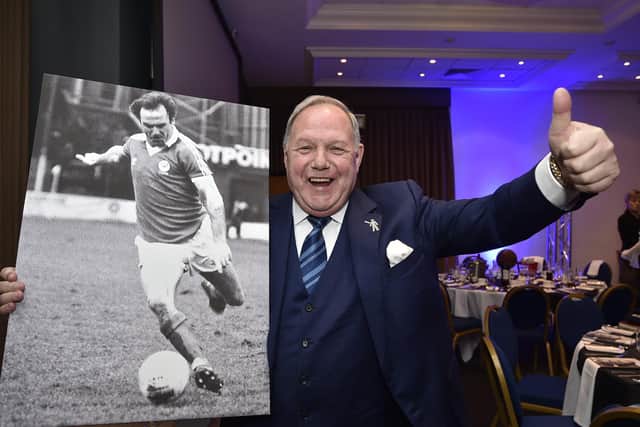Posh director of football Barry Fry with a photo of Tommy Robson in action.