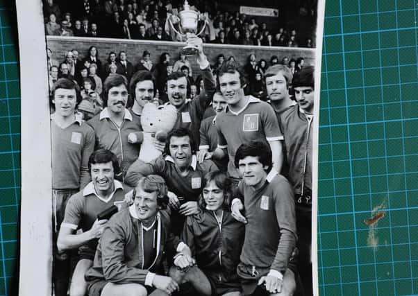 The 1973-74 Posh Fourth Division title-winning side. Captain John Cozens is holding the trophy, Tommy Robson is just below him.