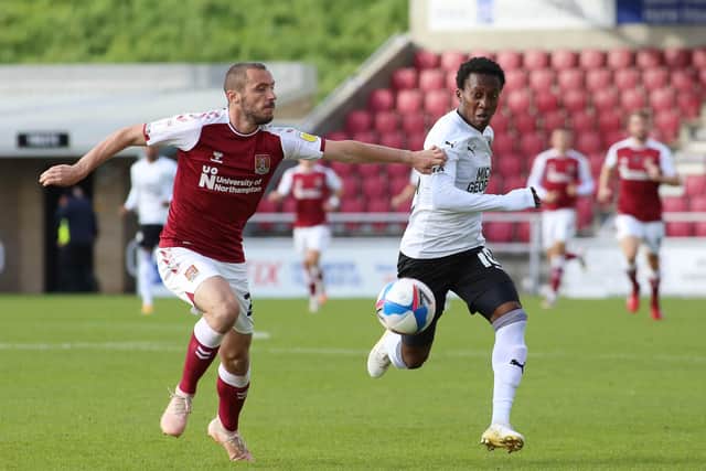 Siriki Dembele of Peterborough United takes on Michael Harriman of Northampton Town. Photo: Joe Dent/theposh.com.