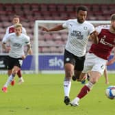 Nathan Thompson of Peterborough United in action with Fraser Horsfall of Northampton Town. Photo: Joe Dent/theposh.com.