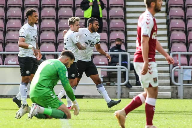 Posh defender Nathan Thompson celebrates scoring his goal against Northampton Town with teammates. Photo: Joe Dent/theposh.com.